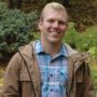 man in flannel and jacket in woods